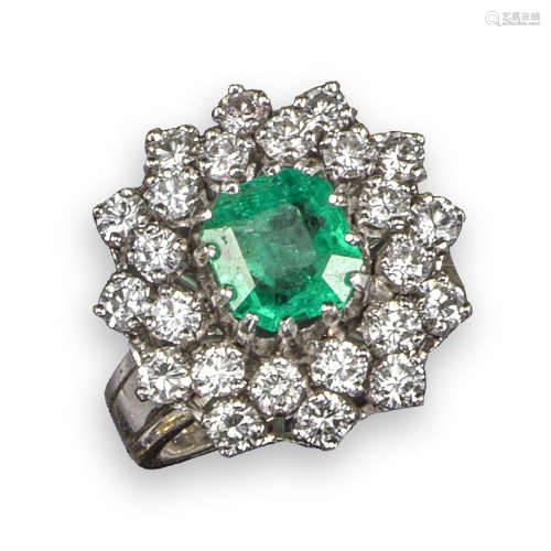 An emerald and diamond cluster ring