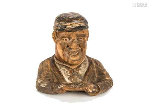 A late 19th century Black Forest carved inkwell, in the form of a bust of a man with song book,