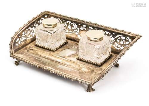 An early 20th century silver plated ink stand, with pierced gallery surround, pen rest in front of a