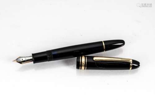 A modern Mont Blanc fountain pen, black with gold mount, having 14ct white and yellow gold nib