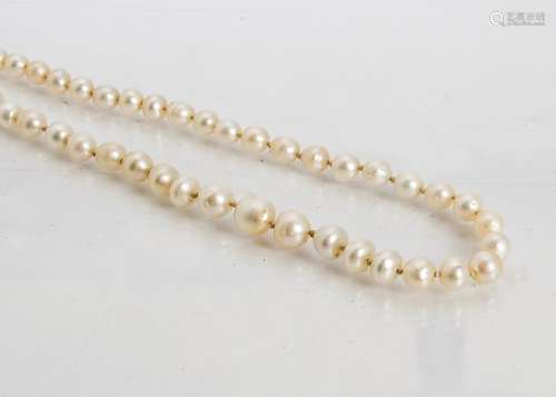 An early 20th Century graduated natural pearl necklace, the knotted necklace united by a diamond and