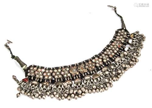 A North African white metal fringe/choker necklace, set with paste panels on a black cord and thread