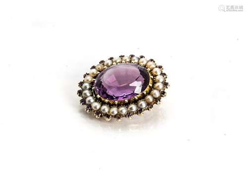 An amethyst and seed pearl oval brooch, the oval mixed cut central amethyst in rubbed over bead