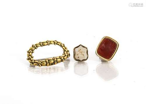 Two 19th Century fob seals, set with carnelian and onyx, and a 19th Century gilt metal brooch