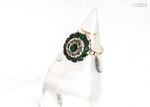 An emerald and diamond continental dress ring, the oval setting with central collet set emeralds