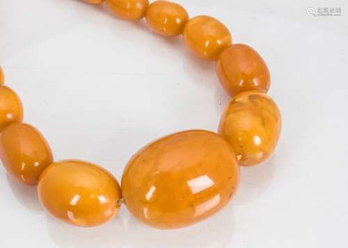 A graduated amber bead necklace, the largest oval bead measuring 4cm wide x 3cm, the smallest 1.