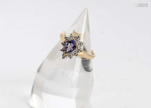 A tanzanite and diamond cluster ring, the central pear cut tanzanite within an illusion set