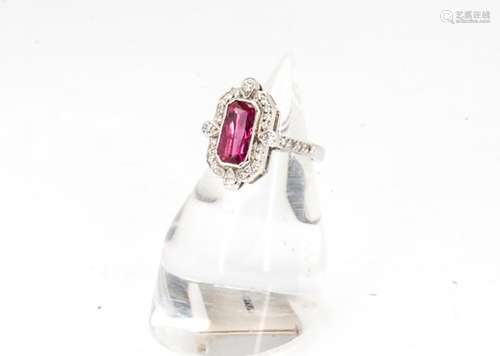 An Art Deco Style ruby and diamond dress ring, the rectangular setting centred with scissor cut