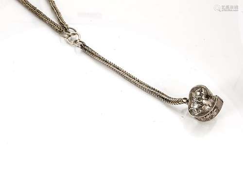 A Chinese white metal heart shaped hinged pendant, with open recess for prayer scroll, on a fine