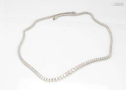 An impressive diamond line necklace, of graduated form, the claw set brilliant cuts on white 18ct