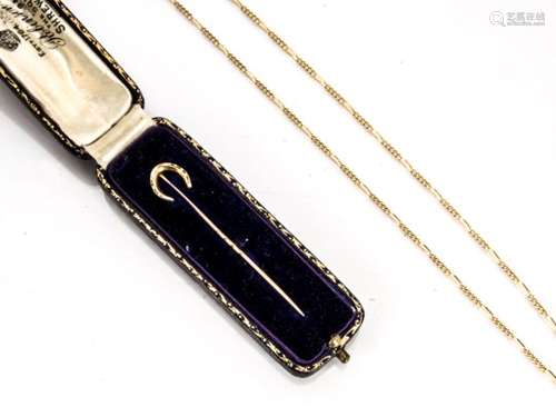 An Edwardian 15ct gold horseshoe stick pin, in velvet case together with a 9ct gold curb linked