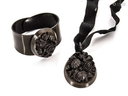 A Victorian jet mourning bangle, and a Victorian jet mourning pendant on silk cord, both with carved