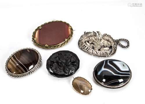 A Georgian agate gilt metal framed brooch, three others, a jet brooch carved with acorns and a white