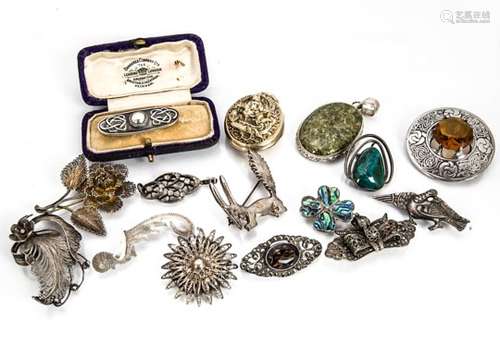 A collection of silver brooches and lockets, including an art nouveau cased rectangular brooch, an