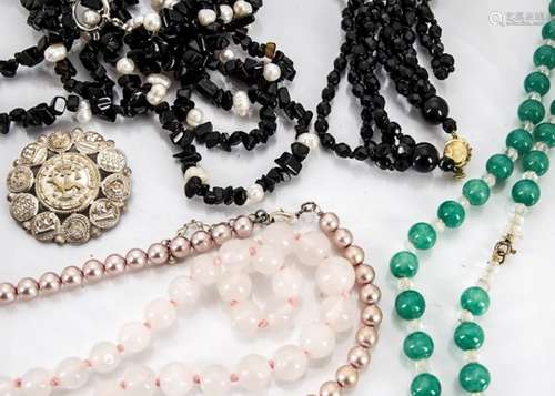 A large collection of costume jewellery, including necklaces, beads, brooches and other items