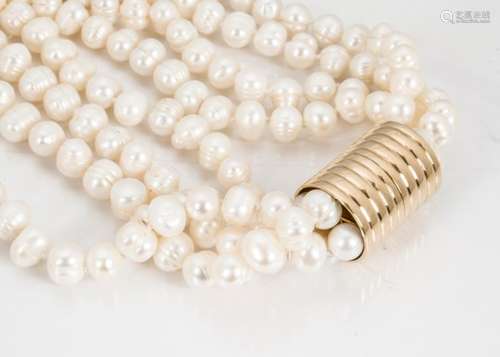 A contemporary four strand freshwater knotted pearl choker, on a cylindrical barrel clasp, 38cm long