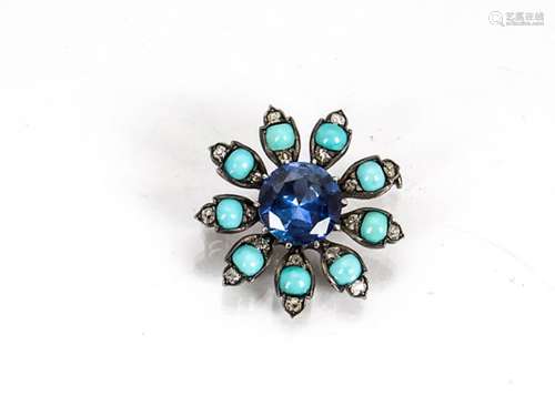 A multi gem set silver set flower head brooch, centred with a large circular cut synthetic sapphire,