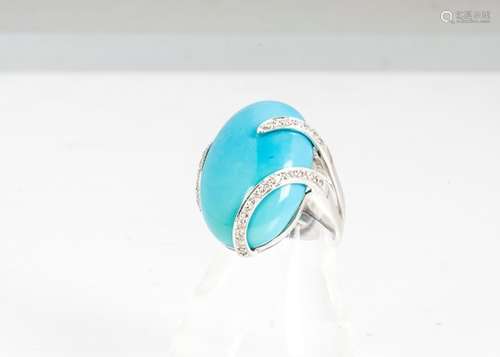 A continental 750 marked turquoise and diamond dress ring, the oval cabochon in a wrapped diamond