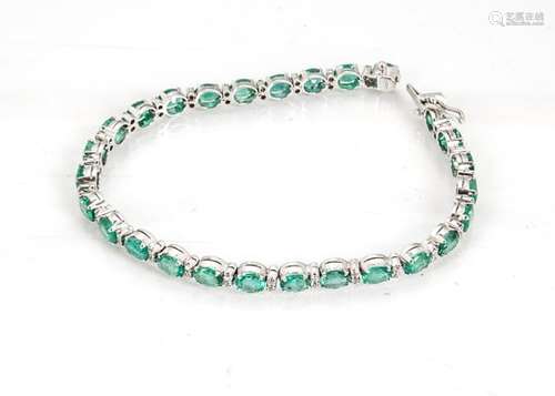 An emerald and diamond line bracelet, the oval mixed cut emeralds alternately set with pairs of