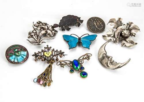 A collection of silver brooches, including an enamel butterfly, a base metal and enamel drop and