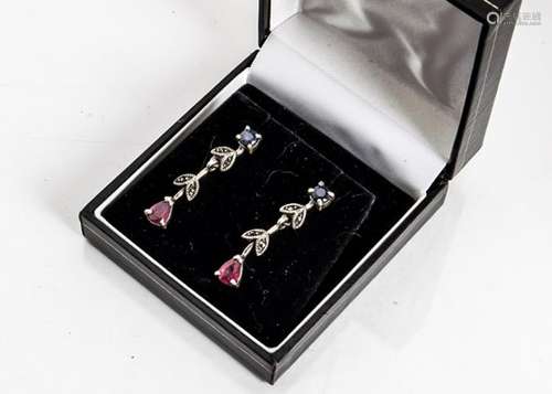 A pair of sapphire and ruby silver set drop earrings, the circular cut sapphires supporting