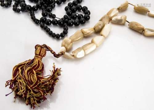 A string of Middle Eastern mother of pearl worry beads, with a red and gold silk stung tassel