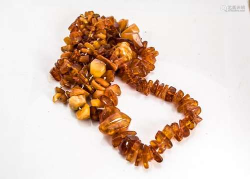 A string of graduated rough Baltic amber stones, the translucent beads culminating in a large