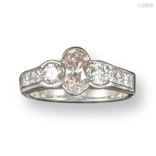 A fancy and white diamond three-stone ring