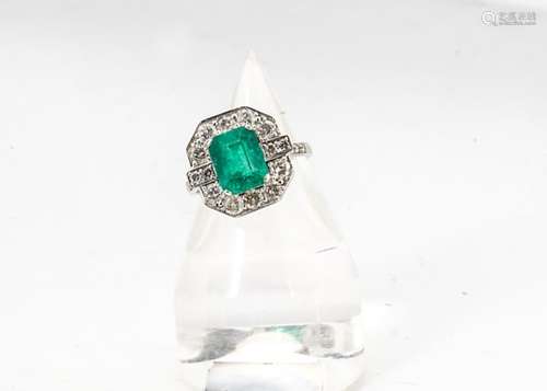 An emerald and diamond Art Deco style dress ring, the central emerald cut emerald in four claw