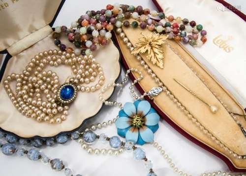 A large quantity of costume jewellery, including simulated pearls, amber beads, bangles etc