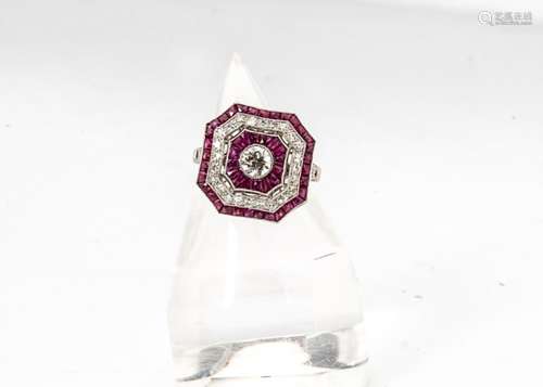 An Art Deco style ruby and diamond platinum set dress ring, the octagonal tablet with central