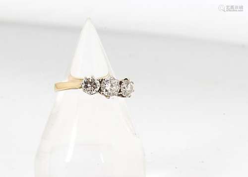 A three stone diamond ring, in white 18ct gold setting, the three claw set diamonds on plain