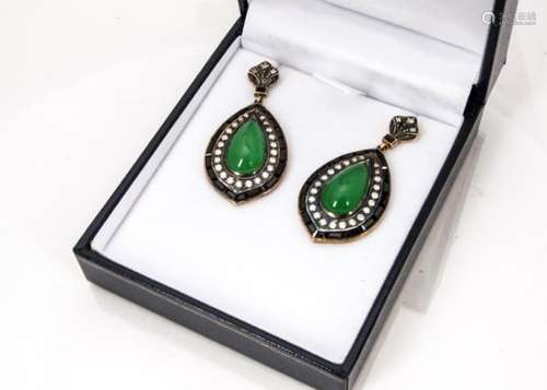 A pair of jade, diamond and onyx Art Deco style drop earrings, the pear shaped cabochon jade centres