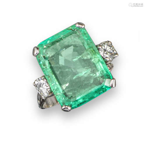 An emerald and diamond three-stone ring