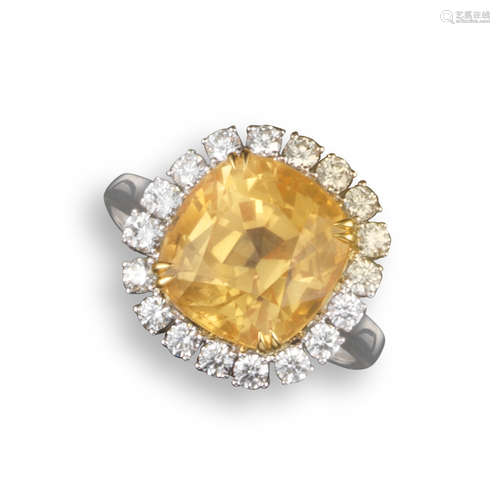 A yellow sapphire and diamond cluster ring