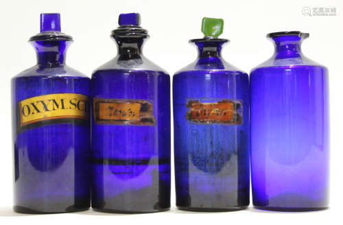 Group of nine blue glass apothecary bottles and stoppers (9)