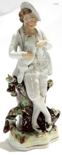 Mid-19th century Staffordshire figure of a boy with dog, modelled standing against a branch, 23cm