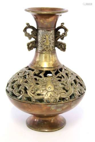 Oriental metal ware vase, the reticulated body decorated with a scroll design with ear-shaped