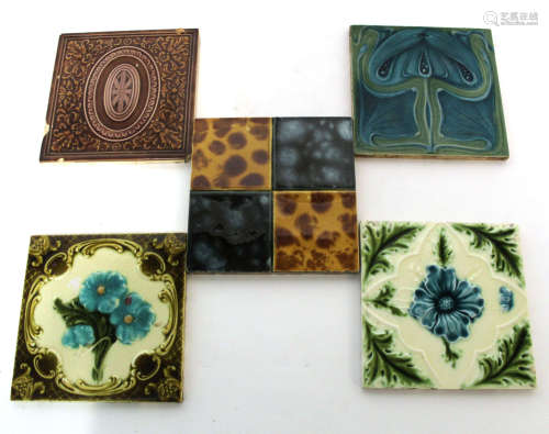 Collection of fourteen Victorian glazed pottery tiles including two Minton tiles with an Art Nouveau