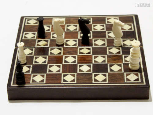 Wooden box with inlaid bone squares and a bone/ivory chess set to the interior