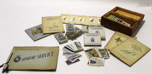 Wooden box containing a variety of cigarette cards from the 1930s, a Senior Service cigarette box