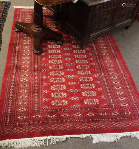 Modern Caucasian style rug, multi-gull border, central panel of lozenges and red field, 195 x 128cm