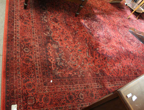 Good quality modern red ground floor rug with floral design and multi-gulled border, 175cm wide x