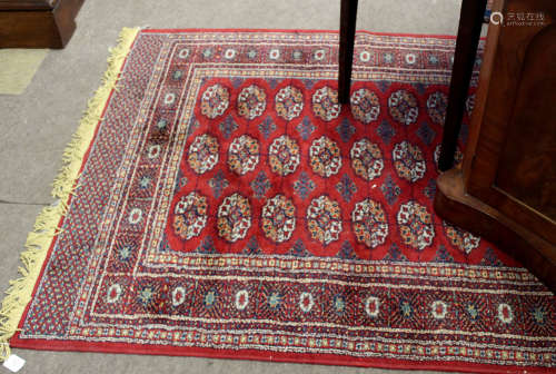 Modern Caucasian rug, central panel of lozenges, multi-gull border, mainly red field, 131 x 165cm