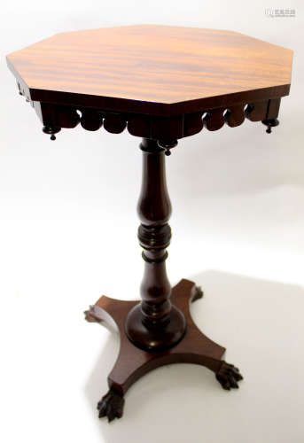 Mahogany octagonal pedestal table with ring turned column and quadruped base with paw feet, 42cm