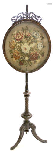 Victorian walnut pole screen, the central panel inset with Berlin type wool work floral decoration