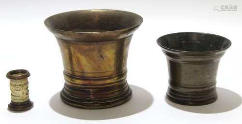 Two bronze mortars and a small ivory cylindrical carved vase, largest mortar 14cm high