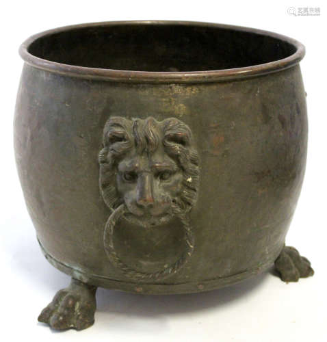 Copper log or kindling container of cylindrical form applied on either side with lion mask ring