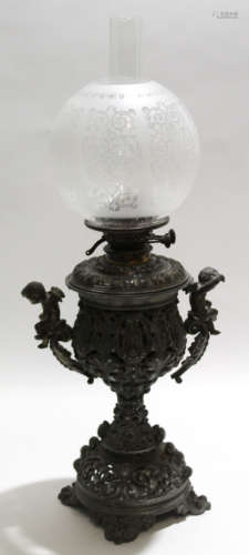 Metal pierced oil lamp with cherub handles, decorated in Renaissance style with circular globe, 88cm