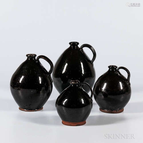 Four Black-glazed Graduated Jugs